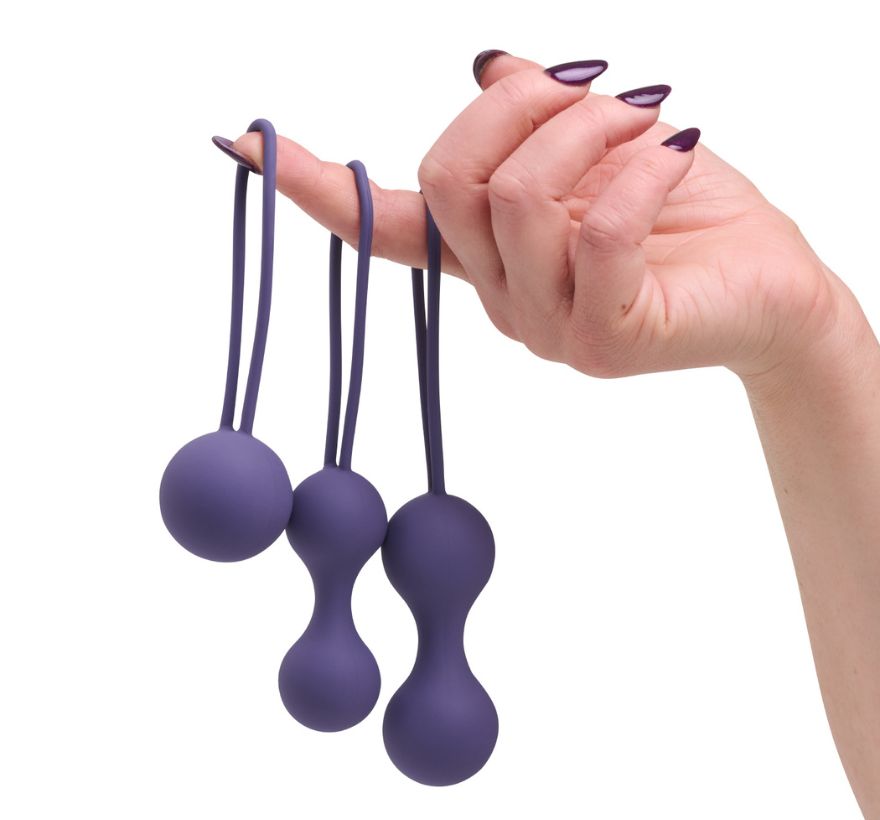 So Divine Kegel Ball Set held in hand – compact and soft-touch kegel exercisers designed for ease of use and comfort during menopause.